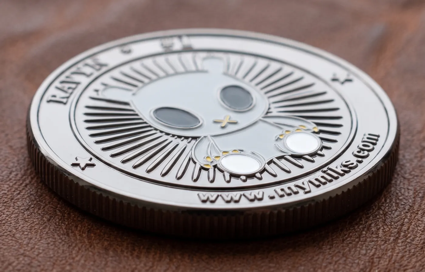 The Mymiks coin, which lives in the pouch on the plush toy's back